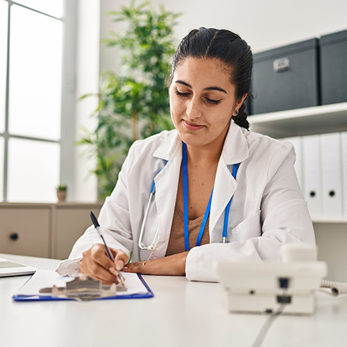 physician filling out form in her office