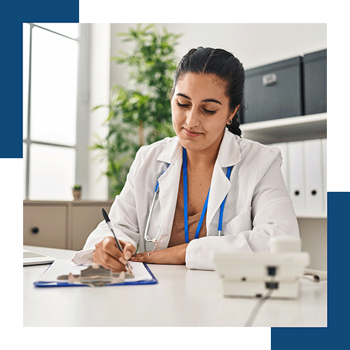 physician filling out form in her office