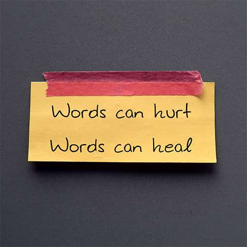 paper sign reading words can hurt and words can heal